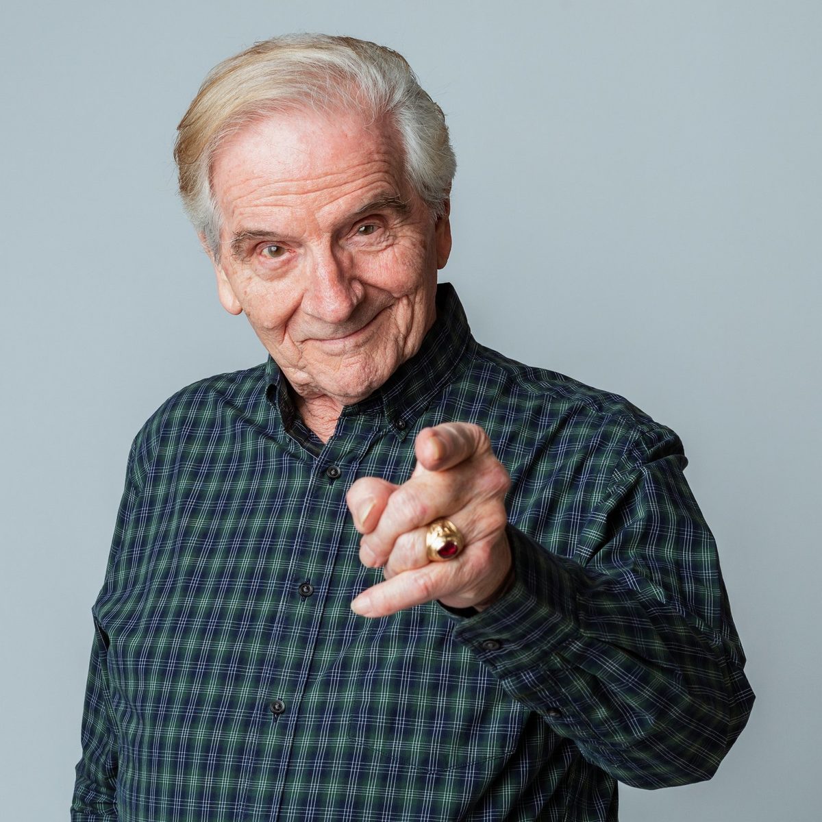 Un senior souriant montre l'écran de son ordinateur portable